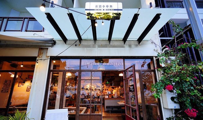 迷路小章魚餐酒館 門面玻璃落地窗,夜裡透出溫暖燈光